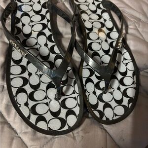 Black and silver monogram coach flip flops